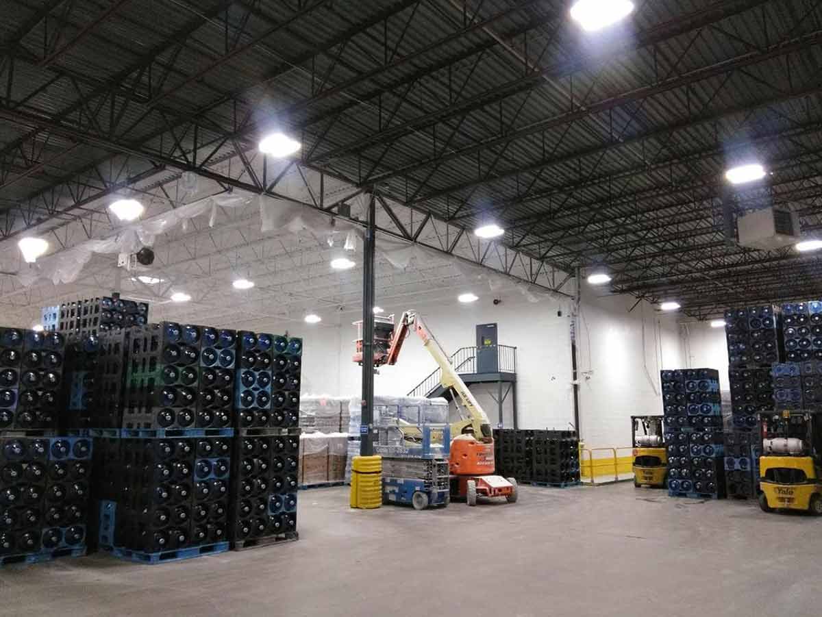 Commercial warehouse interior with construction equipment and an elevated work platform