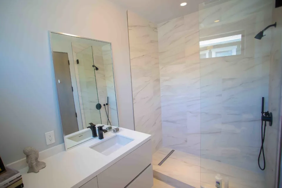 Glass shower and tiled bathroom walls